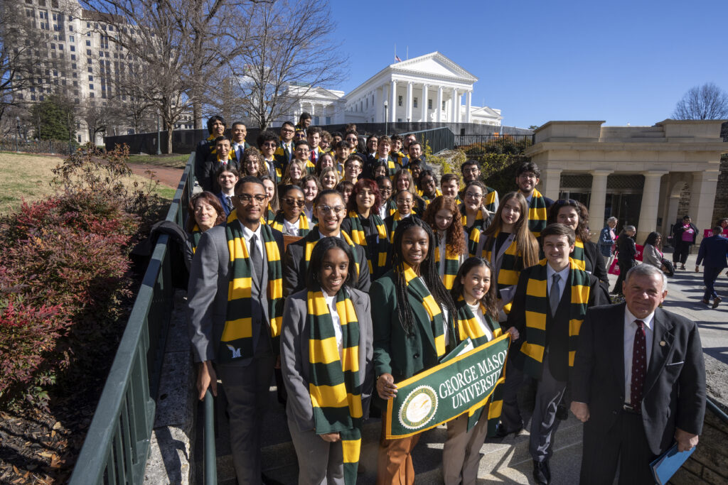 A group of George Mason students standing on the steps of the Capitol Building in Richmond, VA.