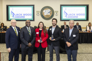 Photo of Iulia Fratila and Jesse Van Wick standing with President Gregory Washington, Rector Michael Meese, and John Wood.