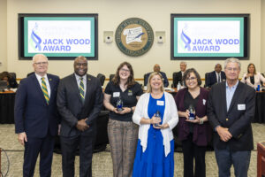 Representatives from George Mason's New Student and Family Programs, Contemporary Student Services, and the Old Town Fairfax Business Association standing with President Gregory Washington, Rector Michael Meese, and John Wood.